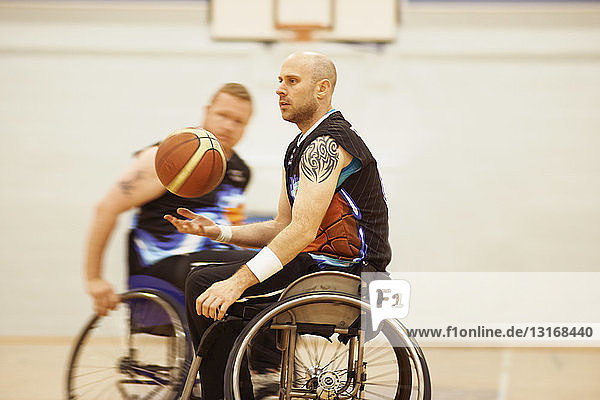 Wheelchair basketball player bouncing ball