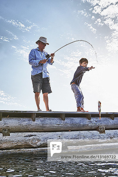 Grandfather and grandson fishing  Utvalnas  Sweden