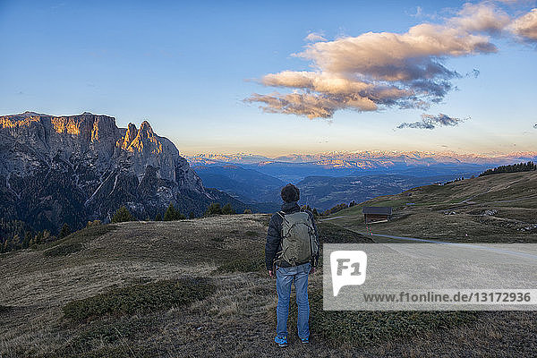 Italy  South Tyrol  Seiser Alm  Hiker in front of Schlern at sunrise