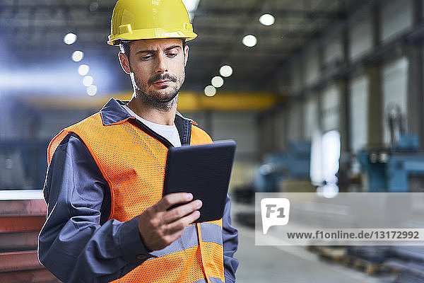 Man using tablet in factory