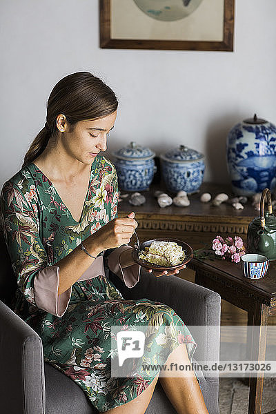 Young woman eating piece of home-baked cake