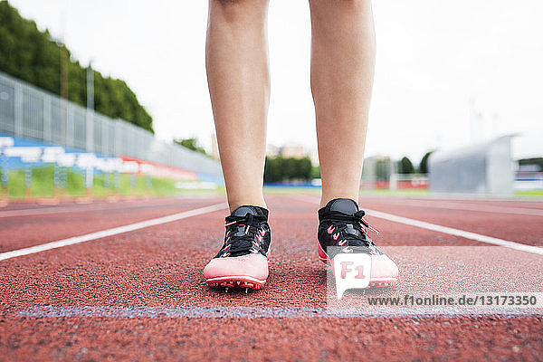 Feet of a runner  standing on race track