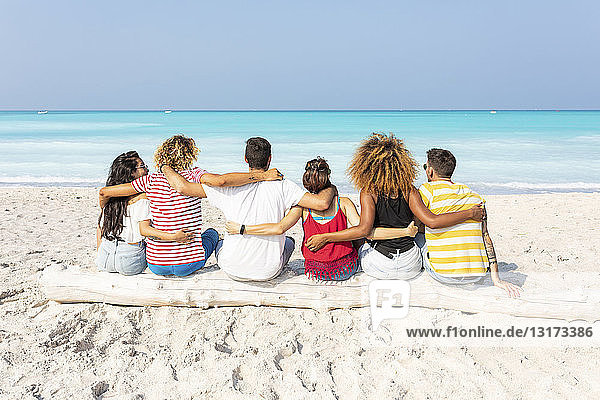 Friends taking a break  sitting on the beach