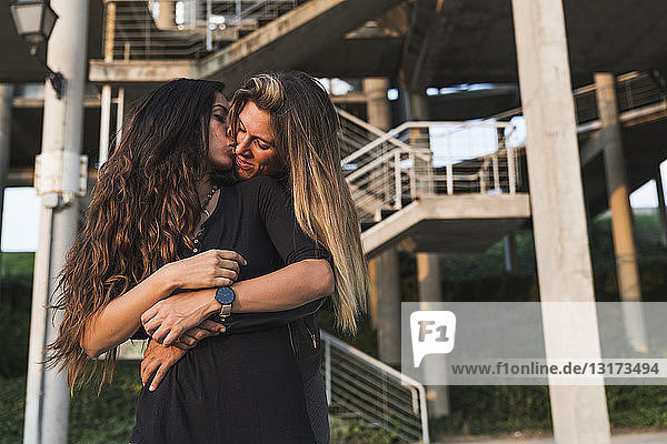 Lesbian couple kissing outdoors