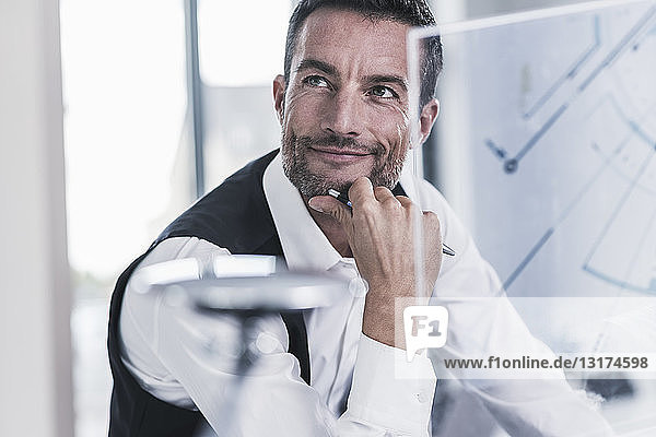 Businessman working in office  using futuristic computer with a transperant screen