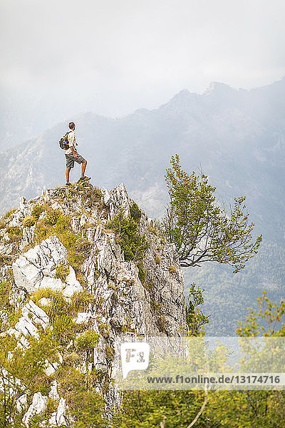 Italy  Massa  man standing on top of a peak in the Alpi Apuane mountains