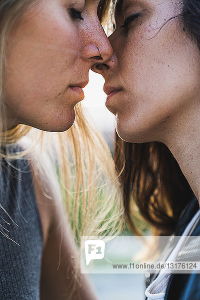 Close-up of affectionate lesbian couple about to kiss