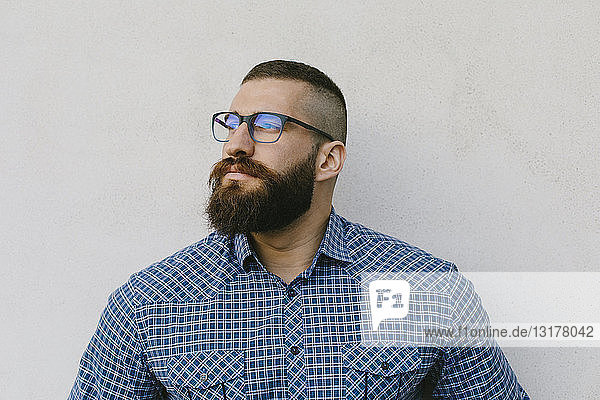 Porträt eines bärtigen Hipster-Geschäftsmannes mit Brille und kariertem Hemd