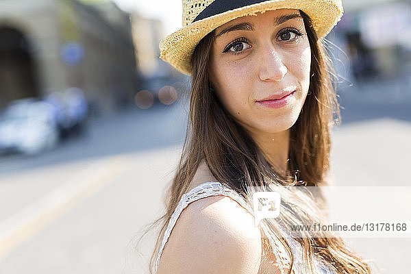 Portrait of young woman wearing straw hat