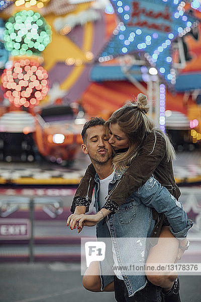Young couple in love  embracing at a funfair