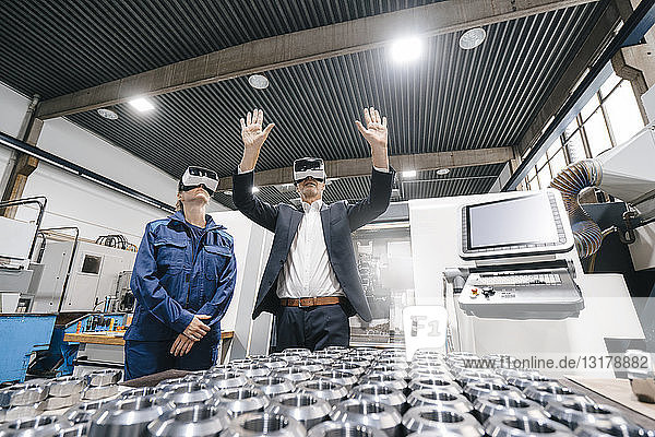 Businessman and skilled worker in high tech enterprise  using VR glasses