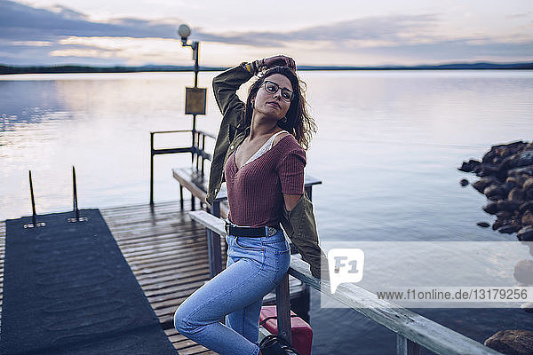 Pretty young woman posing on a pier at Lake Inari  Finland