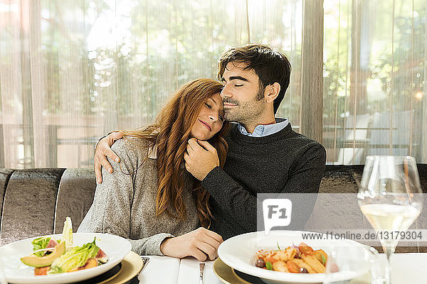 Couple in love sitting at table in a restaurant