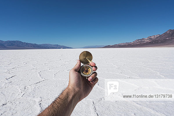 USA  California  Death Valley  man's hand holding compass
