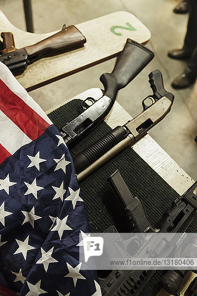 Rifles and American flag on table