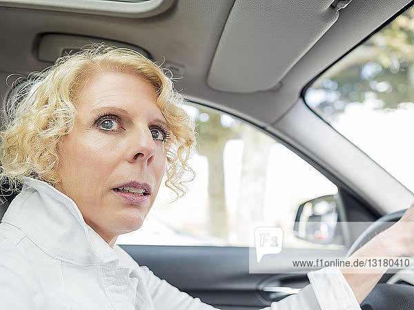 Portrait of mature woman driving car