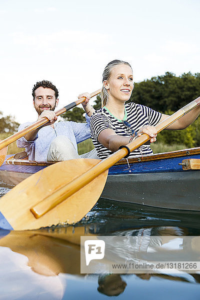 Young couple enjoying a trip in a canoe on a lake