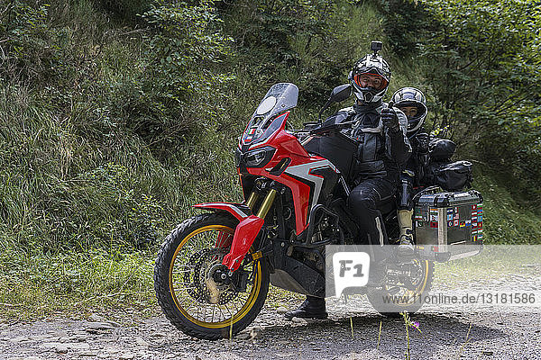 Father and son having a break during a motorbike trip