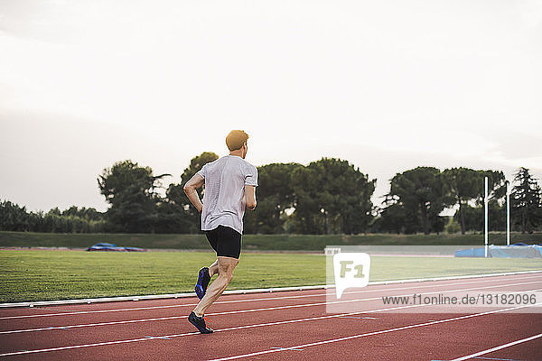 Athlete running on tartan track