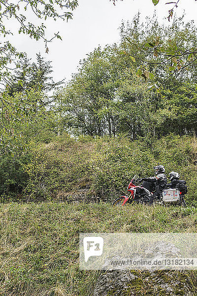 Father and son on a motorbike trip in the countryside