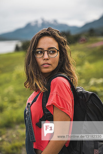 Young woman with a backpack traveling Norwegian Lapland
