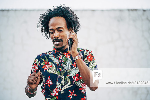 Portrait of man on the phone wearing shirt with floral design