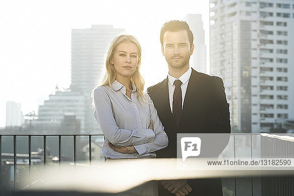 Portrait of businesswoman and businessman on rooftop