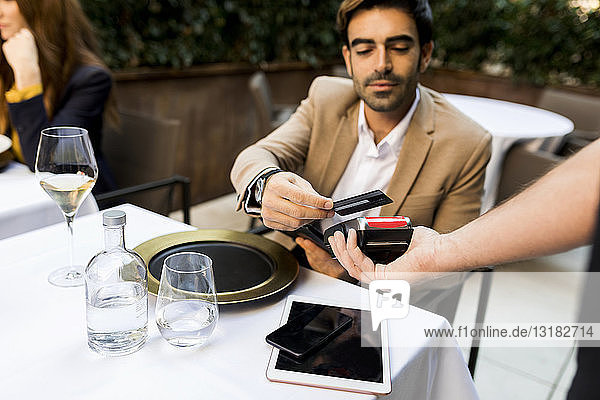Man paying with credit card in a restaurant