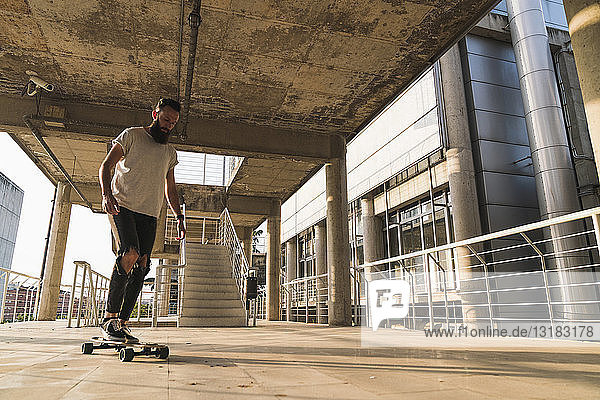 Junger Mann fährt Skateboard in der Stadt