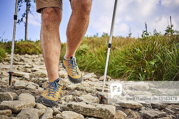 Close-up of man hiking on the trail