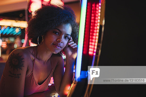 USA  Nevada  Las Vegas  portrait of young woman at slot machine in a casino