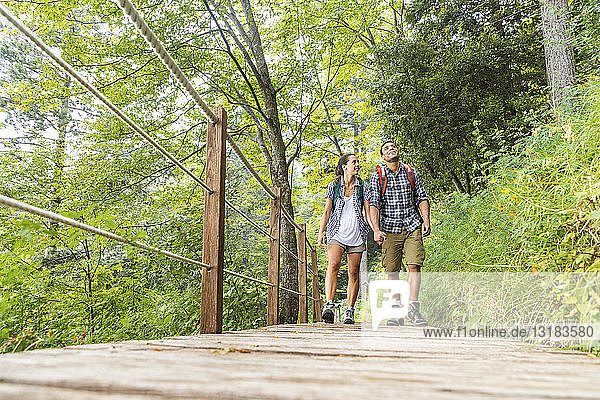 Italy  Massa  young couple hiking and walking on a boardwalk in the Alpi Apuane