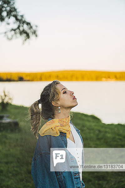 Portrait of a beautiful young woman at a lake