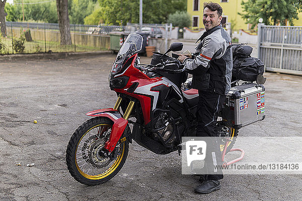 Portrait of smiling man preparing for a motorbike trip