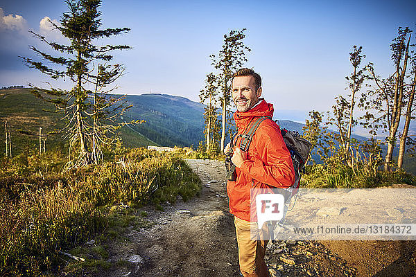 Portrait of smiling man hiking in the mountains
