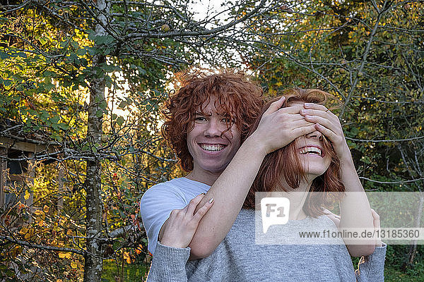 Brother and sitser having fun together in autumn