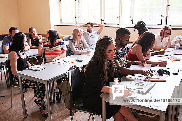 Hochwinkelansicht von multiethnischen Studenten  die im Klassenzimmer lernen