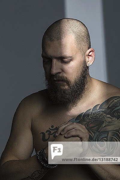 Bare chested man with tattoos