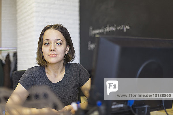 Portrait confident businesswoman working at computer in office