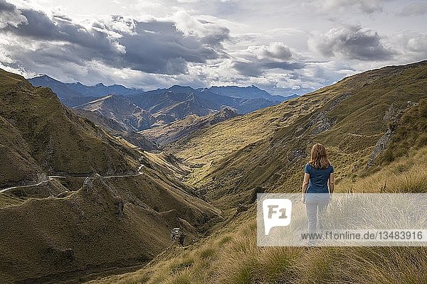 Female hiker looking down towards Skippers Canyon  Queenstown  Otago  South Island  New Zealand  Oceania