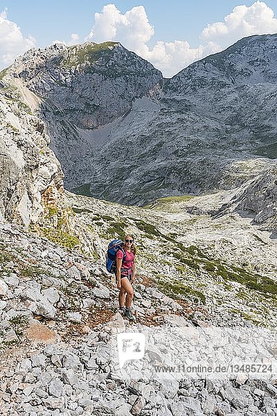 Hiker with rucksack  hiking trail in the Funtenseetauern  Steinernes Meer  Berchtesgaden National Park  Berchtesgadener Land  Upper Bavaria  Bavaria  Germany  Europe