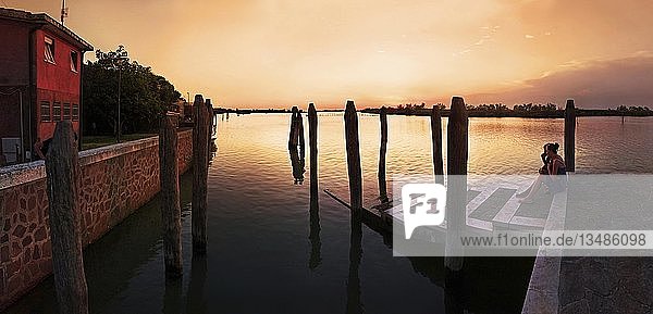 Mother and daughter watching the sunset at Cavallino  Venice  Veneto  Italy  Europe