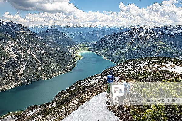 Two hikers on hiking trail  crossing from Seekarspitz to Seebergspitz  view over the lake Achensee  Tyrol  Austria  Europe
