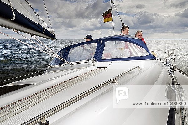 Drei Männer im Cockpit einer Segeljacht bei Revierfahrt