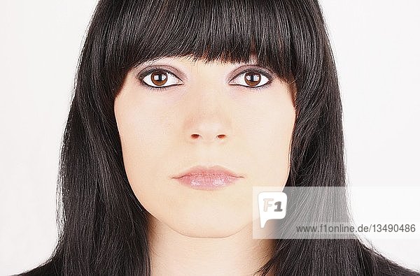 Porträt einer jungen Frau mit großen Augen und dunklem Haar