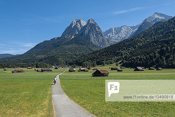 Cyclists on bike tour  cycle path with mountain bike  behind Zugspitze  Tegernauweg  near Grainau  crossing the Alps  Garmisch-Partenkirchen  Upper Bavaria  Bavaria  Germany  Europe