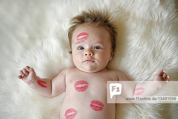 Infant  three months  with red kissing mouth lies on fur  portrait  Baden-WÃ¼rttemberg  Germany  Europe