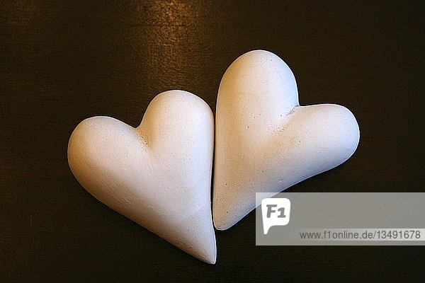 Two white hearts made of plaster
