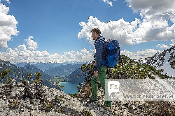 Hiker on hiking trail  crossing from the Seekarspitz to the Seebergspitz  view over the Achensee  Tyrol  Austria  Europe
