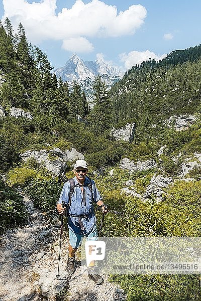 Hiker on hiking trail to KÃ¤rlingerhaus  Watzmann in the back  Berchtesgaden National Park  Berchtesgadener Land  Upper Bavaria  Bavaria  Germany  Europe